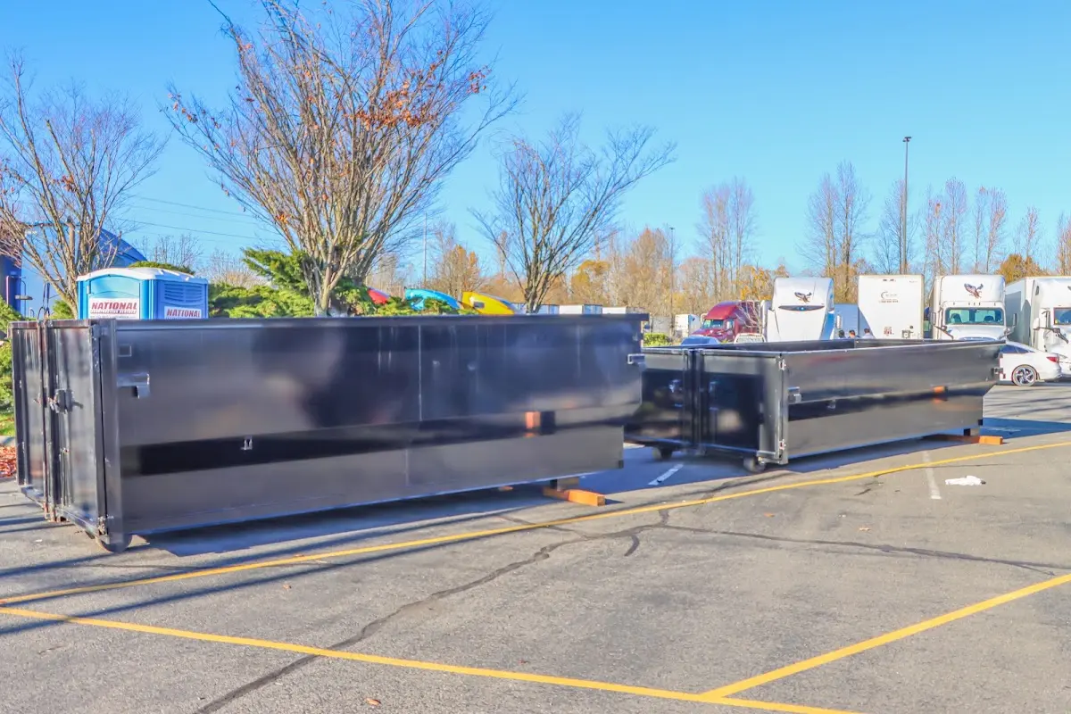Professional dumpster rental service with roll-off container on residential driveway in North Dansville